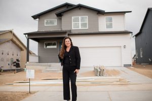 Best realtor near me in front of a new construction home. Greeley Realtor