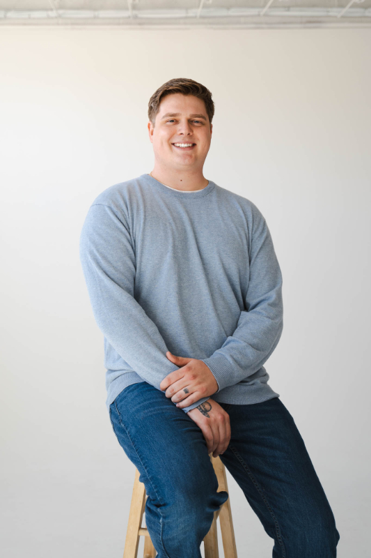 Lane Lemmings seated portrait in a light-blue sweater